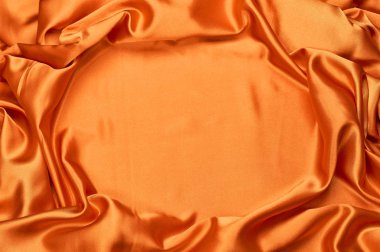 parlak turuncu ipek kumaş ışık arka plan dokusu üzerinde taşan