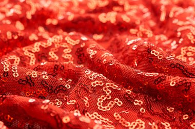 Arka plan doku, desen. İle kumaş kırmızı bordo. Bu Neon pembe birleşiyor payetler bak. Yuvarlak neon pembe birleşiyor payetler yanardöner bir sheen ile şeffaf mor bir kafes arasında örtüşüyor.