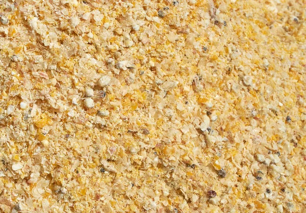 Textura de fundo de sementes trituradas e mistura de grãos para alimentação de animais e aves — Fotografia de Stock