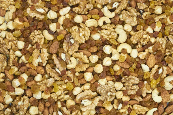 Raisins nuts almonds cashews hazelnuts walnut mix platter texture — Stock Photo, Image