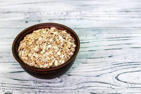 Plate with muesli on a wooden background. Healthy breakfast. Cop — Stock Photo, Image