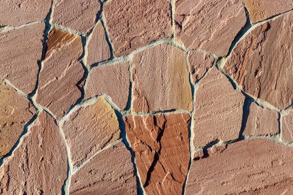 Fragment av en mur gjord av sten. Stenmur. — Stockfoto