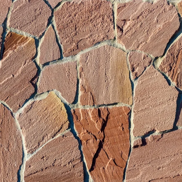 Fragment av en mur gjord av sten. Stenmur. — Stockfoto