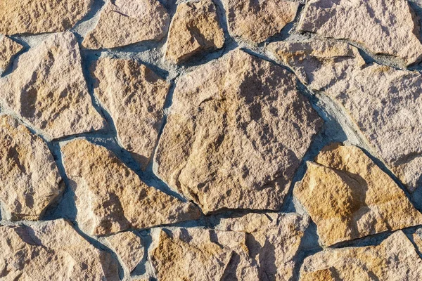 Fragment av en mur gjord av sten. Stenmur. — Stockfoto