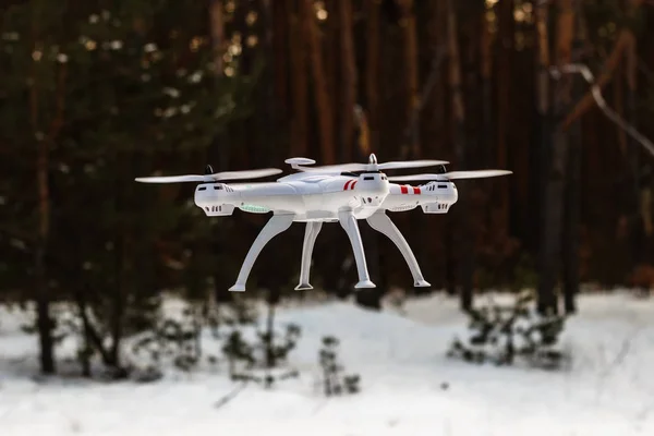 Flight of the drone in the winter forest. The concept of unmanne