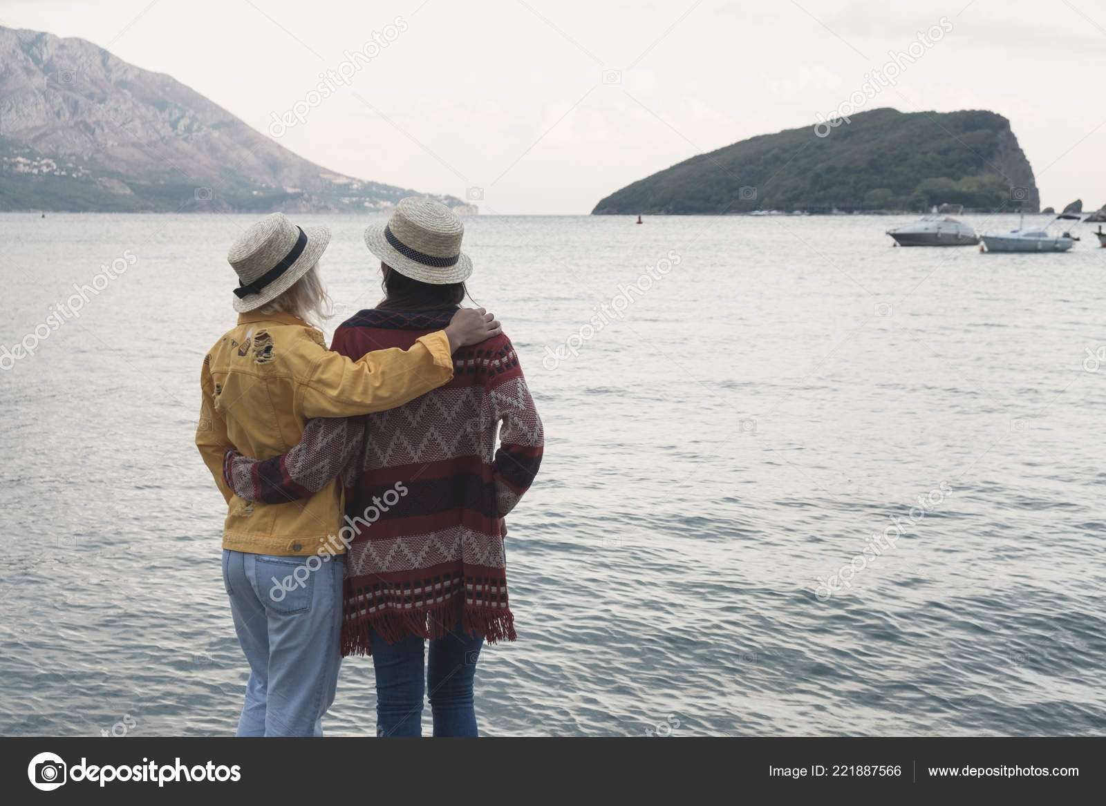 Two Dark Blonde Haired Girls Hats Standing Looking Summer Sea