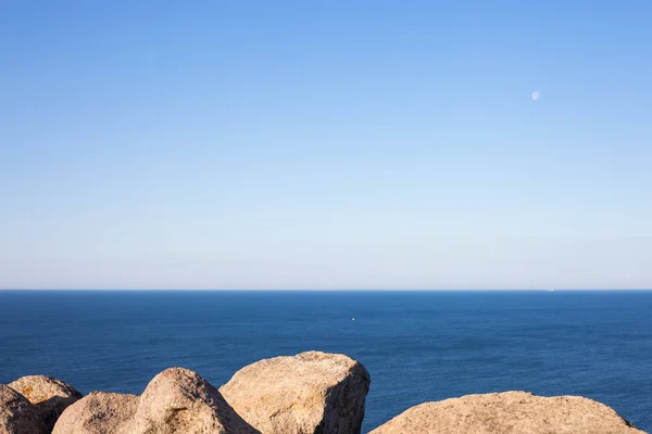 Stones, rocks, blue ocean water and sky horizon background. — Stock Photo, Image