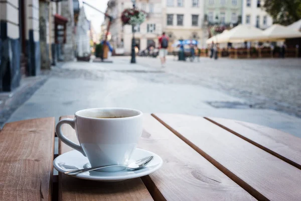 Coffee cup on a table of typical European outdoor cafe — Stock Photo, Image