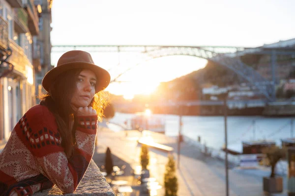 Mujer joven con el pelo largo caminando por la calle de la ciudad al amanecer, vistiendo sombrero y abrigo, disfrutando feliz momento agradable de sus vacaciones — Foto de Stock