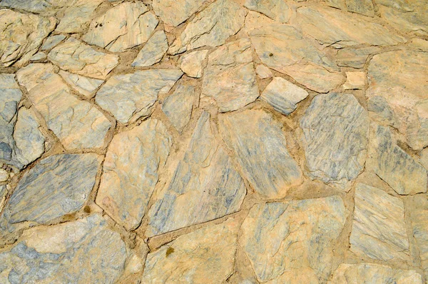 Kaba eski, eski kahverengi doku düzensiz taşlar, cobblestones bristchatku yerde koydu dikiş ile oyulmuş. Arka plan.