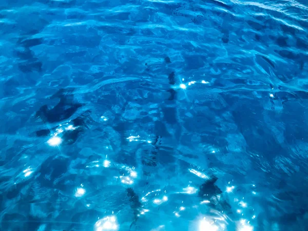 Texture of beautiful blue sea-transparent transparent wet-railing, glowing salt water, sea, ocean, background of sea surface.