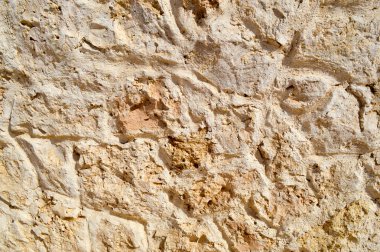 Taştan bir duvar, taş, tuğla, cobblestones, yollar dokusuna gri antik doğal eski sarı kumlu dikişleri ile keskin kenarları ile döşer. Arka plan