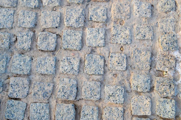 Texture d'un mur de pierre, routes de pierres, briques, pavés, carreaux avec des coutures sablonneuses de gris ancien jaune naturel avec des bords pointus. Le contexte — Photo