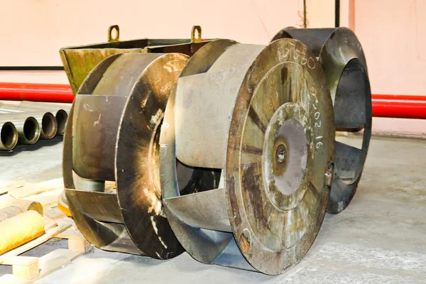 Une grande roue ronde en métal de fer avec des persiennes pour pomper l'eau dans la pompe. Pièce détachée de la pompe de transfert — Photo