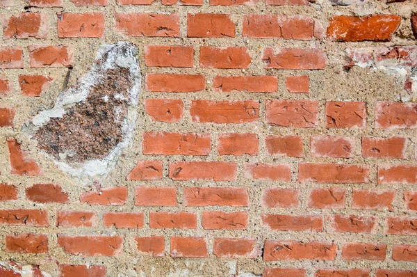 La texture de la vieille pierre antique médiévale dur peeling mur de briques craquelées rectangulaires de briques d'argile rouge et de grandes pierres, pavés. Le contexte — Photo