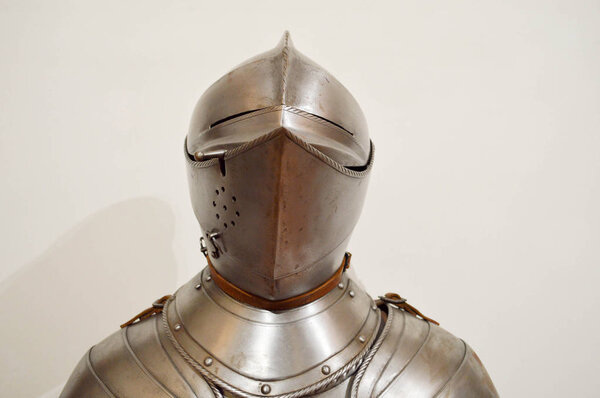 Medieval strong knight warrior chained in iron silvery strong metal armor with a helmet and a visor.