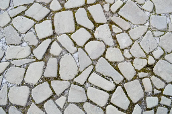 La trama della strada in pietra, pavimentazione, pareti di grandi grigi vecchi medievali rotondo pietre forti, ciottoli. Lo sfondo — Foto Stock