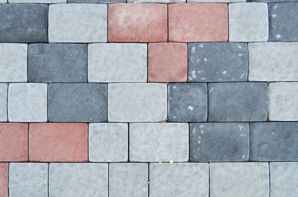 Υφή του γκρίζα ορθογώνια πέτρα σκυροδέματος ταρατσόπλακες στο δρόμο με ραφές. Το φόντο — Φωτογραφία Αρχείου