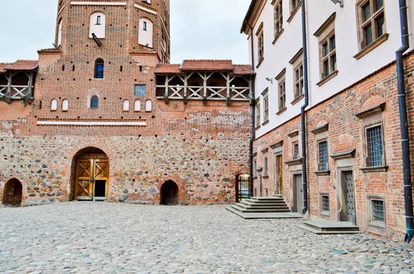 Gamla, antika medeltida slott med spiers och torn, murar av sten och tegel som omges av en skyddande vallgrav med vatten i mitten av Europa. Barock stil arkitektur — Stockfoto