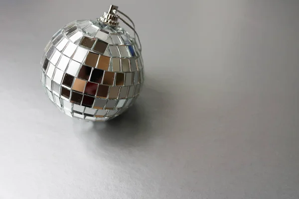 Silver mirror music club disco ball small round glass winter shiny decorative beautiful xmas festive Christmas ball, Christmas toy plastered on sparkles on a black and white background