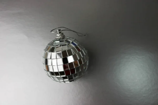 Silver mirror music club disco ball small round glass winter shiny decorative beautiful xmas festive Christmas ball, Christmas toy plastered on sparkles on a black and white background