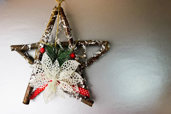 Grande decorativo bella stella di Natale in legno, una ghirlanda di avvento autofatto di rami di abete e bastoni sul festivo Capodanno felice grigio argento sfondo gioioso. Decorazioni natalizie — Foto Stock