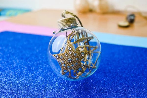 Small round glass transparent vintage homemade smart hipster decorative beautiful Christmas festive Christmas ball, Christmas tree toy with hay, straw inside and with a star — Stock Photo, Image