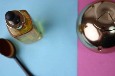 Tonlama ve sarı yağ astar, bir nemlendirici makyaj baz ve mavi mor pembe arka plan üzerinde bir parfüm için doğal doğal ahşap nap fırça ile bir güzellik kutusu. Düz yatıyordu. Üstten görünüm