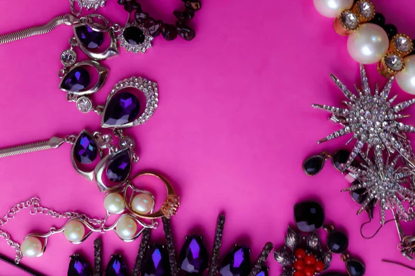Όμορφη πολύτιμα λαμπερά κοσμήματα μοντέρνα λαμπερό Κοσμήματα Σετ, κολιέ, δαχτυλίδια, αλυσίδες, σκουλαρίκια, καρφίτσες με πέρλες και διαμάντια σε ροζ μοβ φόντο. Επίπεδη lay, κορυφαία προβολή, αντιγραφή θέση — Φωτογραφία Αρχείου
