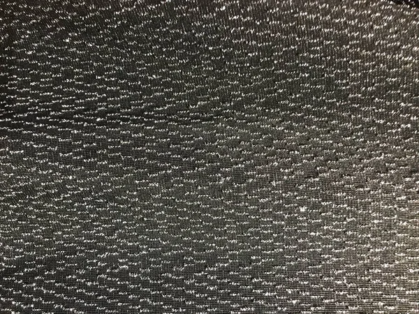 Textuur van zwart synthetisch weefsel met mooie zilverkleurige stippen schittert. De achtergrond — Stockfoto