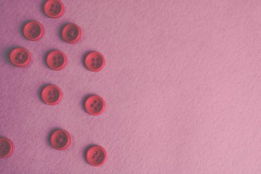 Güzel doku dikiş, dikiş için birçok yuvarlak pembe düğmeli. Uzay kopyalayın. Düz yatıyordu. Pembe, mor arka plan