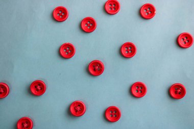 Güzel doku dikiş, dikiş için birçok yuvarlak kırmızı düğmeli. Uzay kopyalayın. Düz yatıyordu. Mavi arka plan