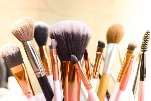 A set of beautiful different soft brushes for make-up from natural nap for the guidance of beauty and the application of a tonal foundation in a stand