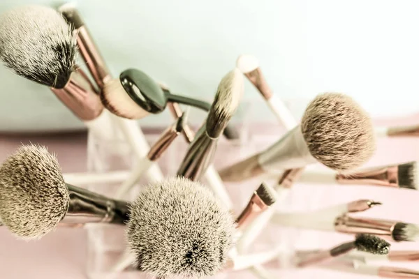 A set of beautiful different soft brushes for make-up from natural nap for the guidance of beauty and the application of a tonal foundation in a stand