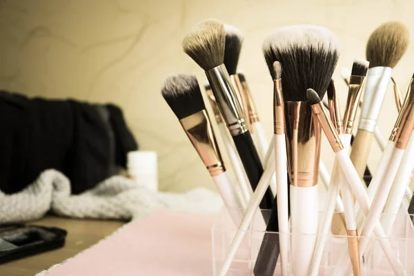 A set of beautiful different soft brushes for make-up from natural nap for the guidance of beauty and the application of a tonal foundation in a stand