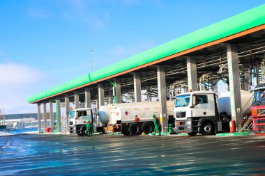 Large green industrial gas station for refueling vehicles, trucks and tanks with fuel, gasoline and diesel in the winter