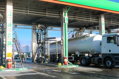 Large green industrial gas station for refueling vehicles, trucks and tanks with fuel, gasoline and diesel in the winter