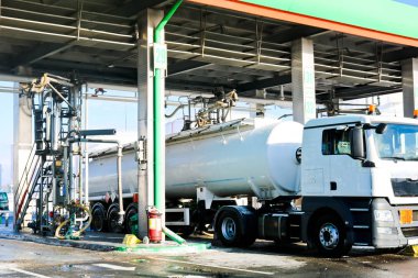 Large green industrial gas station for refueling vehicles, trucks and tanks with fuel, gasoline and diesel in the winter