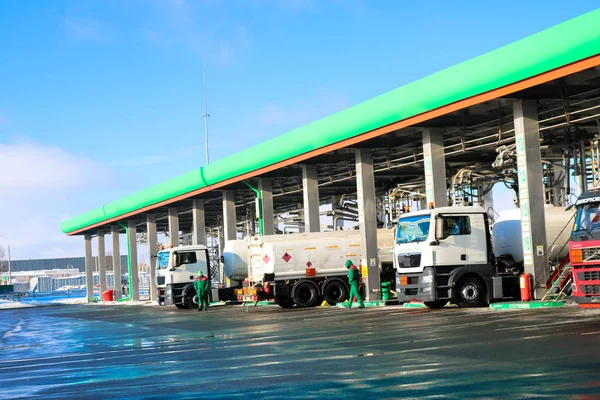 Large green industrial gas station for refueling vehicles, trucks and tanks with fuel, gasoline and diesel in the winter