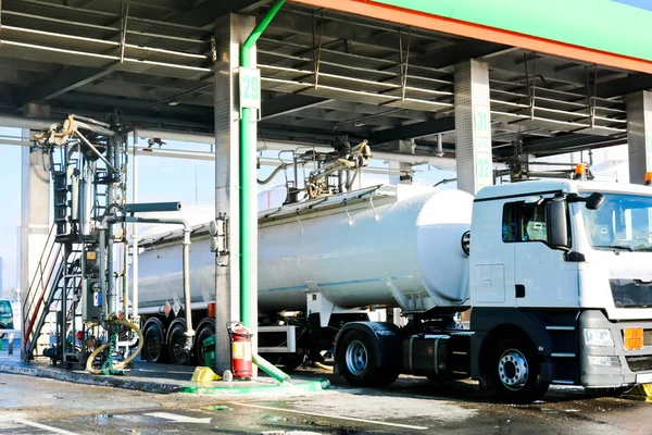 Large green industrial gas station for refueling vehicles, trucks and tanks with fuel, gasoline and diesel in the winter