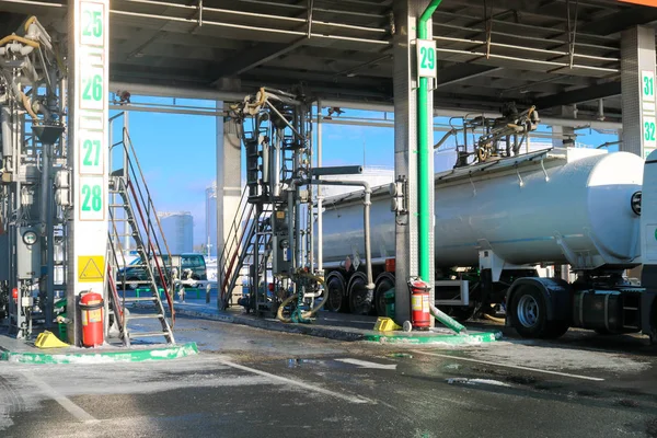Large green industrial gas station for refueling vehicles, trucks and tanks with fuel, gasoline and diesel in the winter — ストック写真