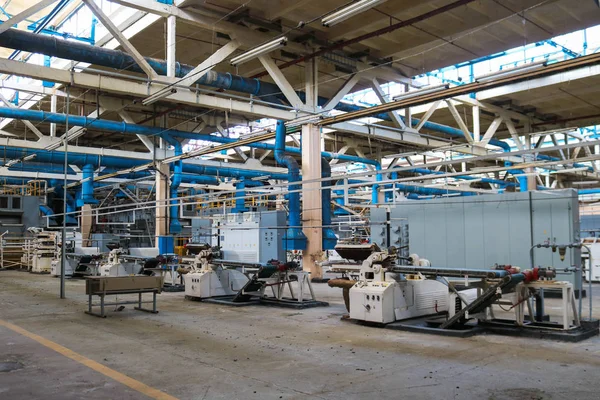 Beautiful metal industrial equipment of a production line at a machine-building plant, a conveyor with machine tools for products. Equipment refinery, petrochemical, chemical plant