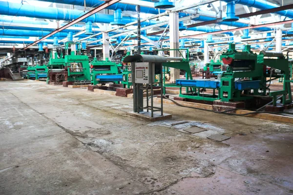 Beautiful metal industrial equipment of a production line at a machine-building plant, a conveyor with machine tools for products. Equipment refinery, petrochemical, chemical plant