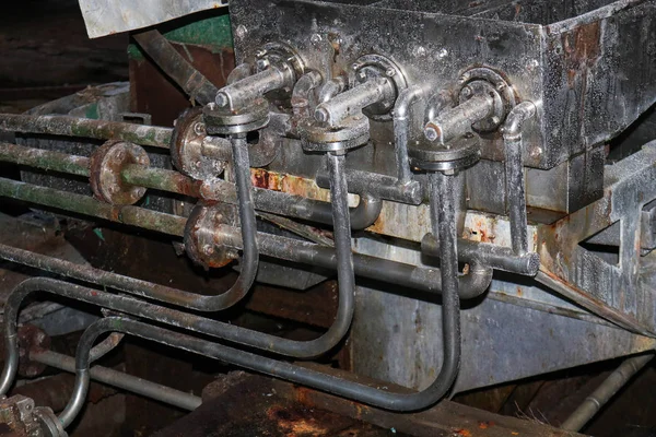 The equipment is open from stainless steel in the shop at an industrial chemical petrochemical machine-building refinery with equipment pipes and flanges