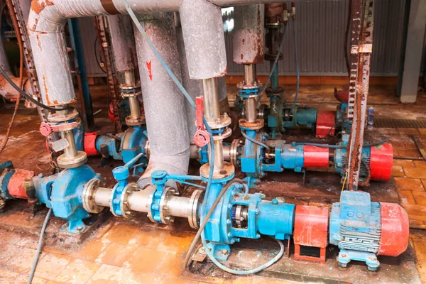 Iron metal centrifugal pumps equipment and pipes with flanges and valves for pumping liquid fuel products at the industrial refinery chemical petrochemical plant shop — Stock Photo, Image