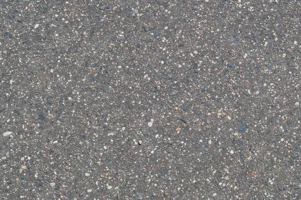 작은 자갈이 있는 돌 흑회색 아스팔트 도로의 배경의 감촉 — 스톡 사진