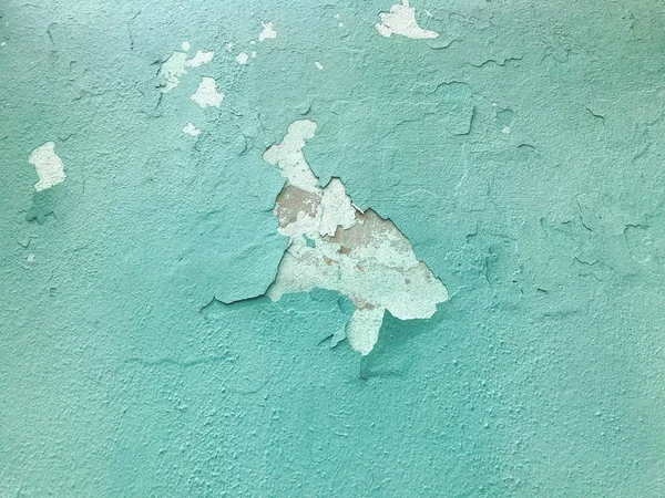 The blue old shabby cracked wall is ancient beautiful with peeli