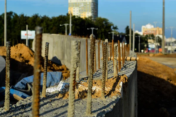 rusty pins sticking out of concrete blocks. laying of blocks for the construction of a new building. block technology for manufacturing houses. making the foundation of the future home