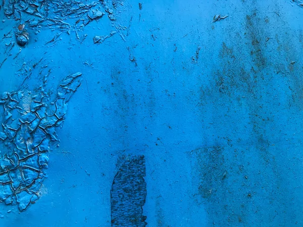 Texture in blue. bright, matte surface. there is a patch on the texture, old texture with damaged paint. rusty texture with smudges of paint, cracked material from time and old age Royalty Free Stock Images