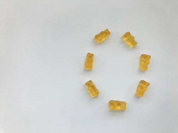 creative edible letter O made from gummy bears. The letter is made from yellow gelatinous and tasty candies. high-calorie dessert, delicious creative alphabet. word study